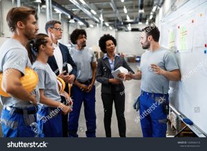 stock photo young factory worker holding presentation about production development to company managers and his 1408546418
