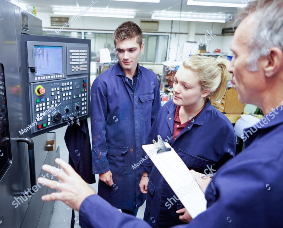 stock photo engineer teaching apprentices to use computerized lathe 165333119 1 3